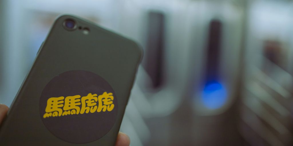 a person holding a cell phone in their hand