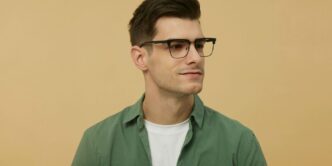 A man wearing glasses and a green shirt