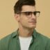 A man wearing glasses and a green shirt