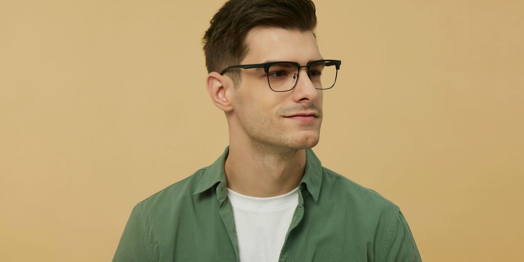 A man wearing glasses and a green shirt