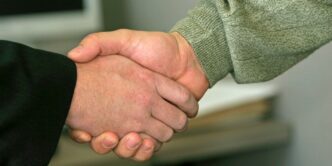 a close up of two people shaking hands