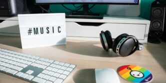 a desk with a keyboard, mouse and headphones