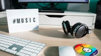 a desk with a keyboard, mouse and headphones