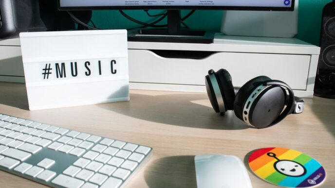 a desk with a keyboard, mouse and headphones
