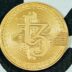 a close up of a coin on a white surface