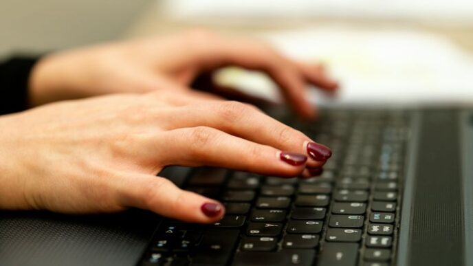 persons hand on black laptop computer