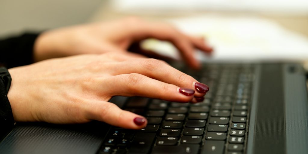 persons hand on black laptop computer