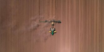an aerial view of a tractor in a field
