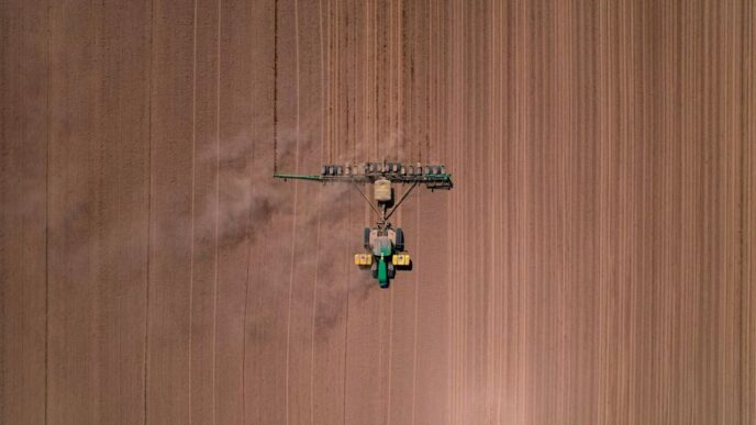 an aerial view of a tractor in a field