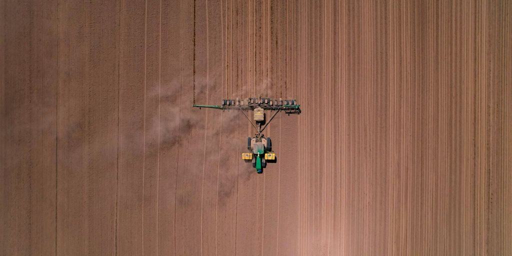 an aerial view of a tractor in a field