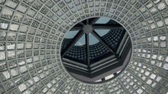 low-angle photo of grey and white concrete dome ceiling