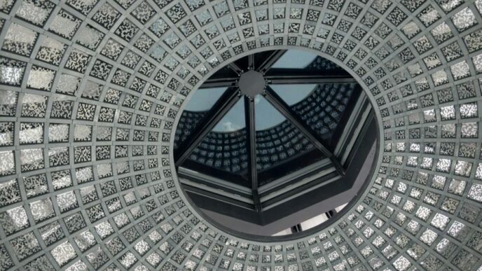 low-angle photo of grey and white concrete dome ceiling