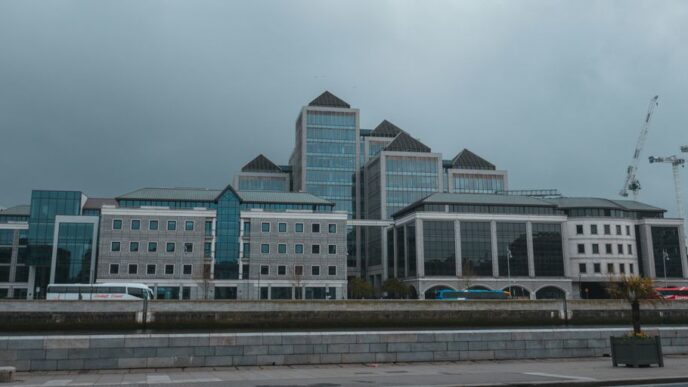 a large building with a lot of windows next to a street
