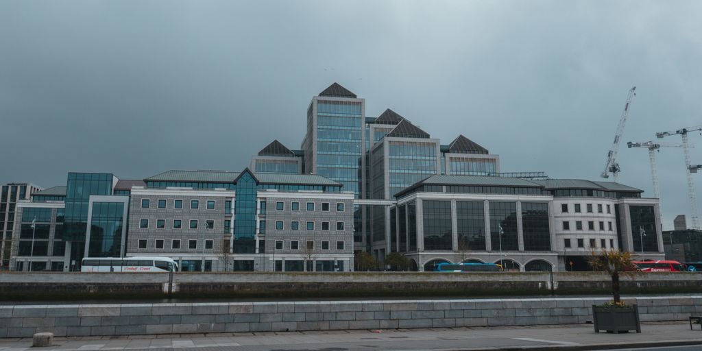 a large building with a lot of windows next to a street
