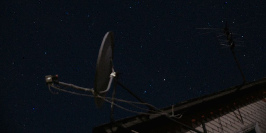 A satellite dish sitting on top of a roof