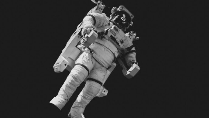 astronaut in white suit in grayscale photography