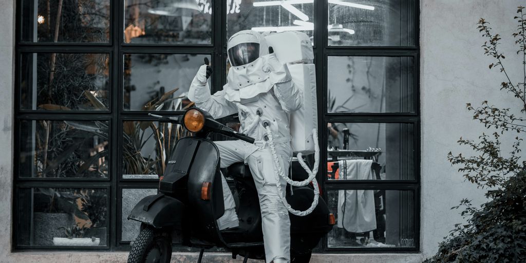 Astronaut rides a scooter in front of a window.