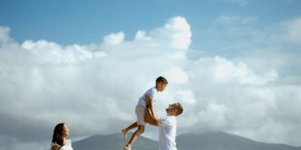 a man is holding a young boy on his shoulders