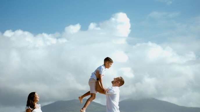 a man is holding a young boy on his shoulders
