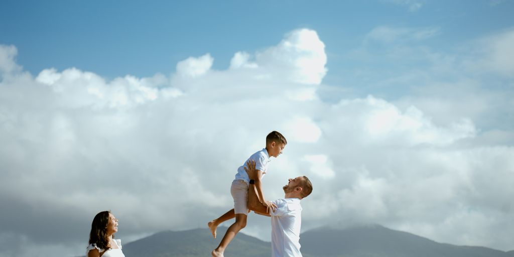 a man is holding a young boy on his shoulders