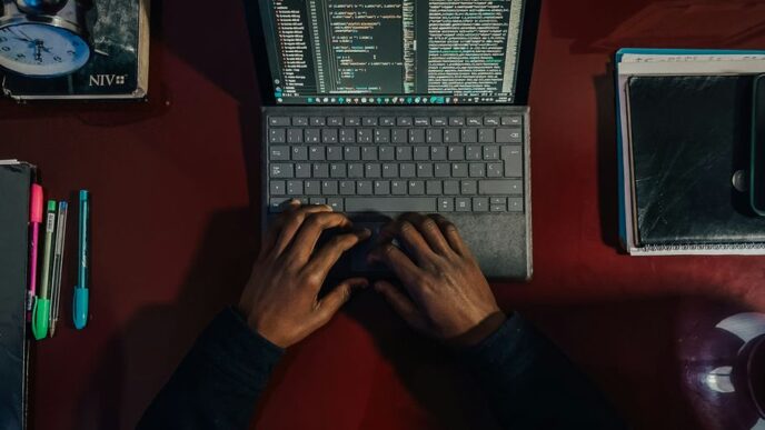 A person sitting at a desk with a laptop