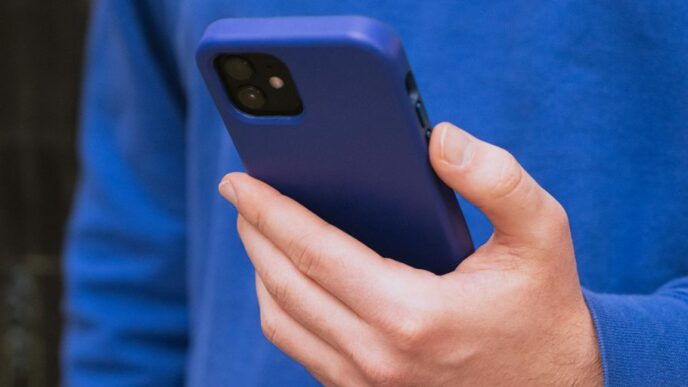 a close up of a person holding a cell phone