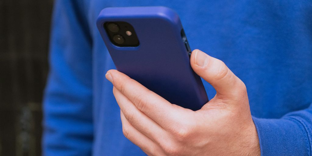 a close up of a person holding a cell phone