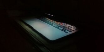 a laptop computer lit up in the dark
