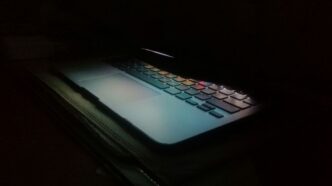 a laptop computer lit up in the dark