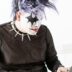 a person in a mask using a laptop