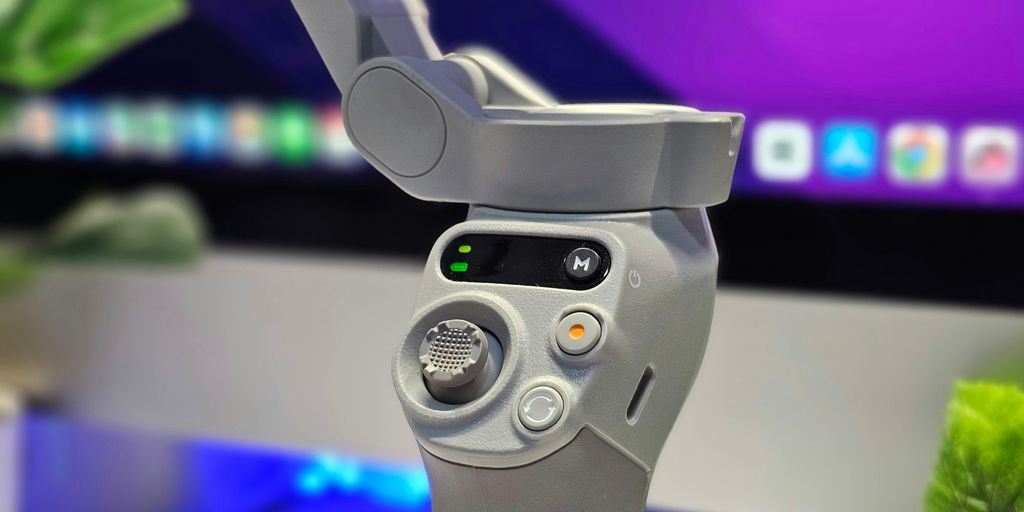 A close up of a video game controller in front of a computer