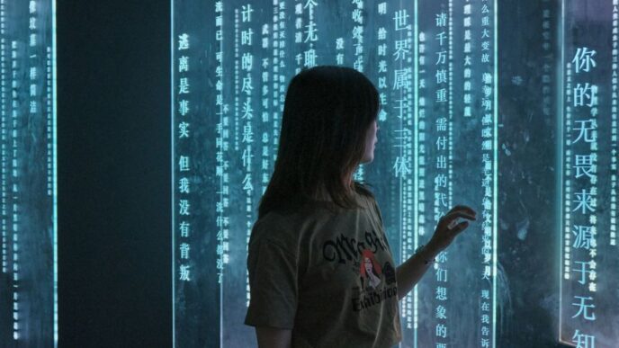 woman in gray crew neck t-shirt standing in front of blue and white string lights