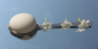 a street light with white flowers on it