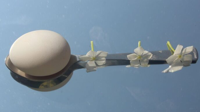 a street light with white flowers on it
