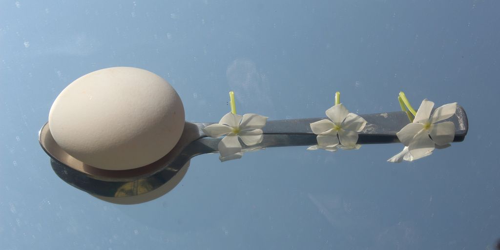 a street light with white flowers on it