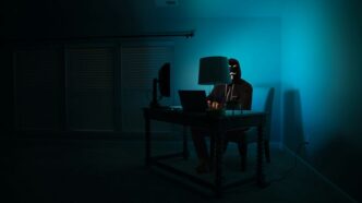 man siting facing laptop