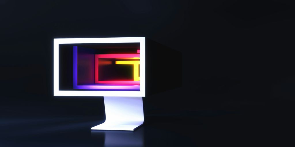a computer monitor sitting on top of a table