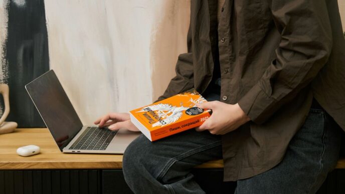 a person sitting on a table with a laptop