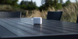 an electronic device sitting on top of a wooden table