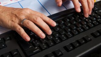 a pair of hands on a keyboard