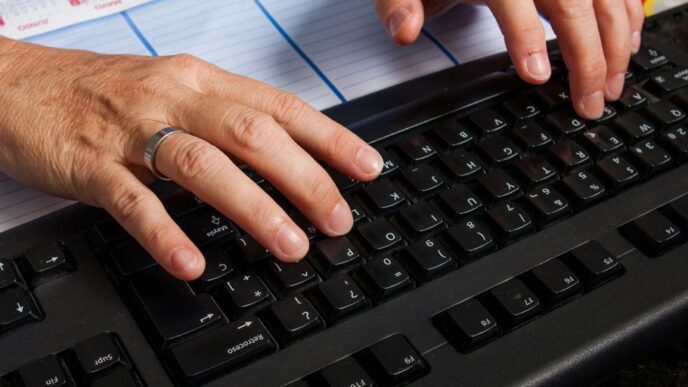 a pair of hands on a keyboard
