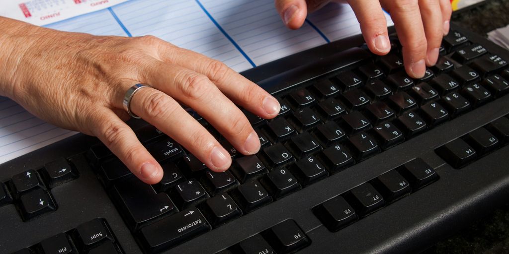 a pair of hands on a keyboard