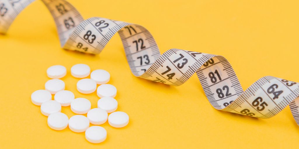 white round medication pill on yellow surface
