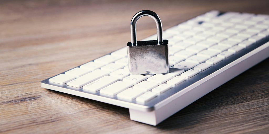 a computer keyboard with a padlock on top of it