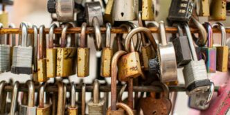 a bunch of padlocks are hanging on a wall