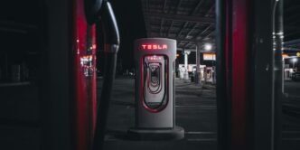 a gas pump in a parking lot at night