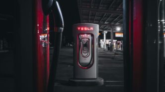 a gas pump in a parking lot at night