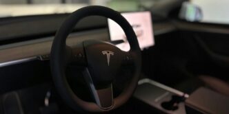 A tesla's steering wheel and interior.