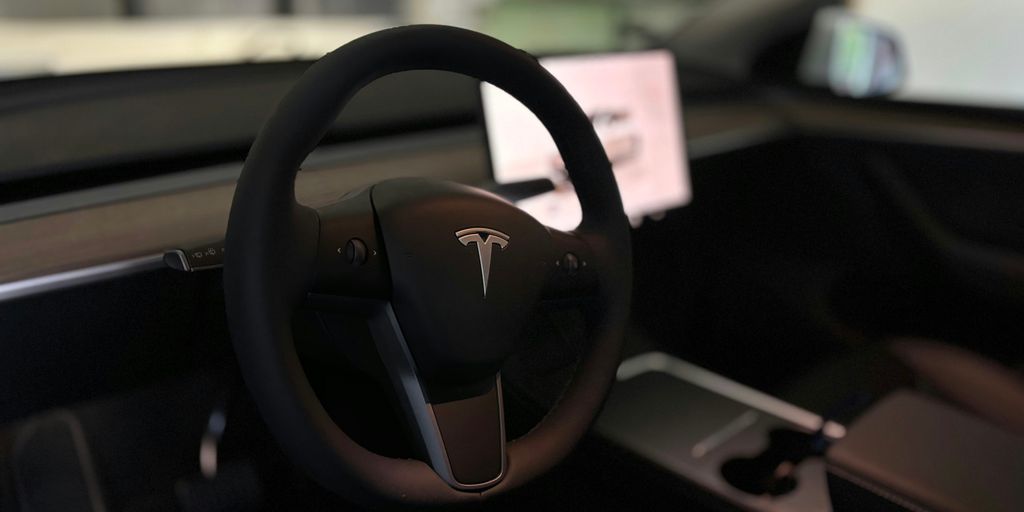 A tesla's steering wheel and interior.
