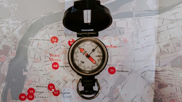 round black metal compass on map